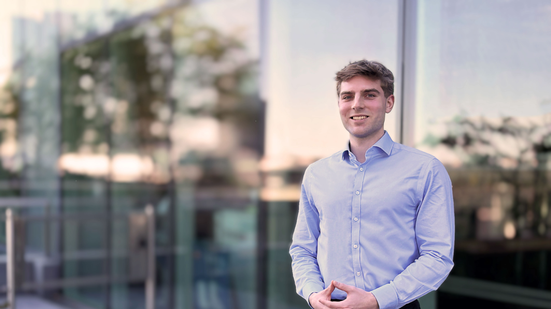Liam O'Kane smiling in an office lobby