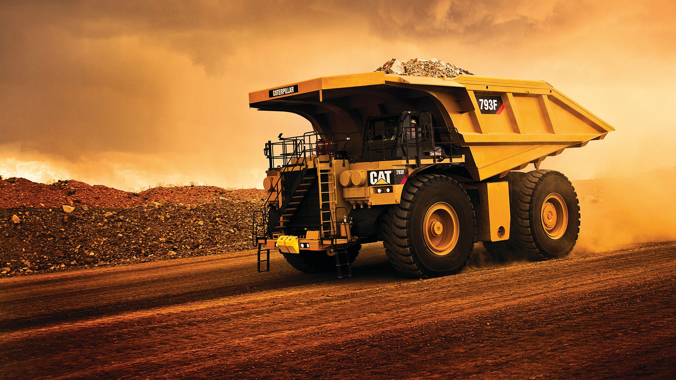 large cat truck driving on dirt road