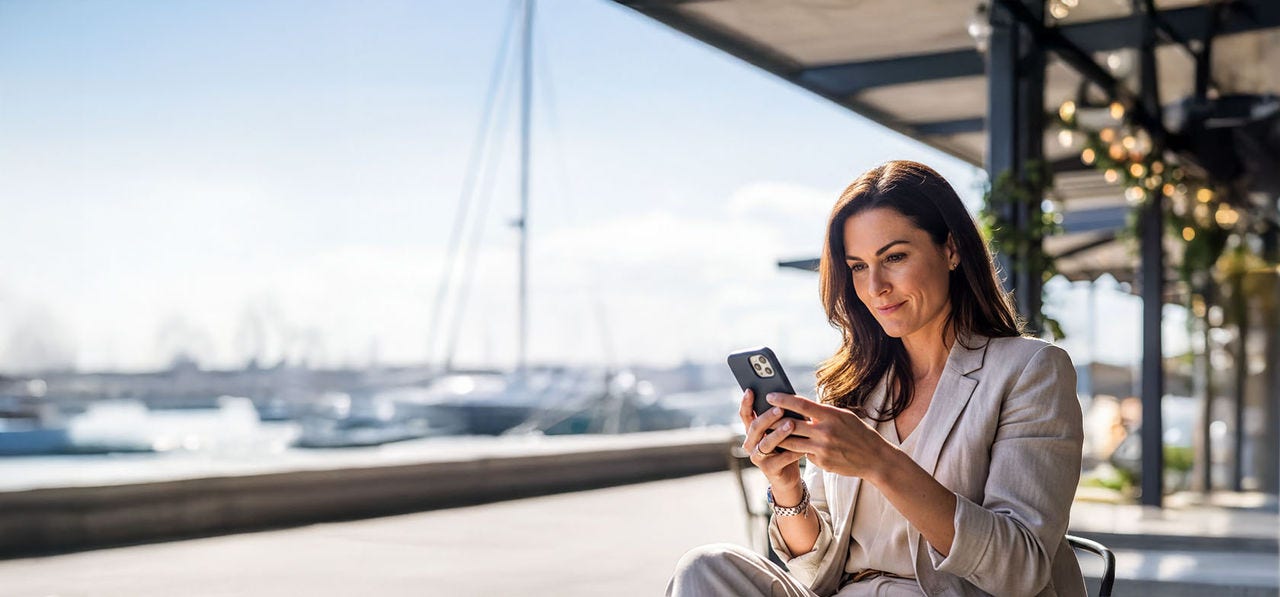 Woman sitting, using a mobile phone