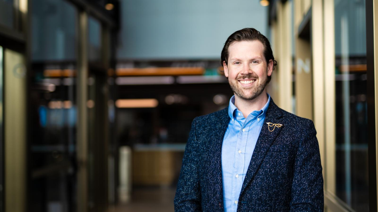 Liam O'Kane smiling in an office lobby