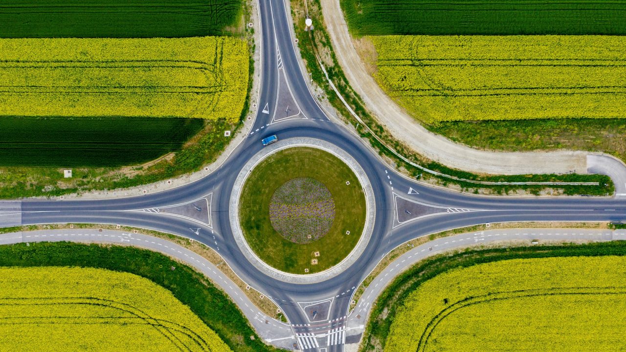 Drone view of roundabout with car driving