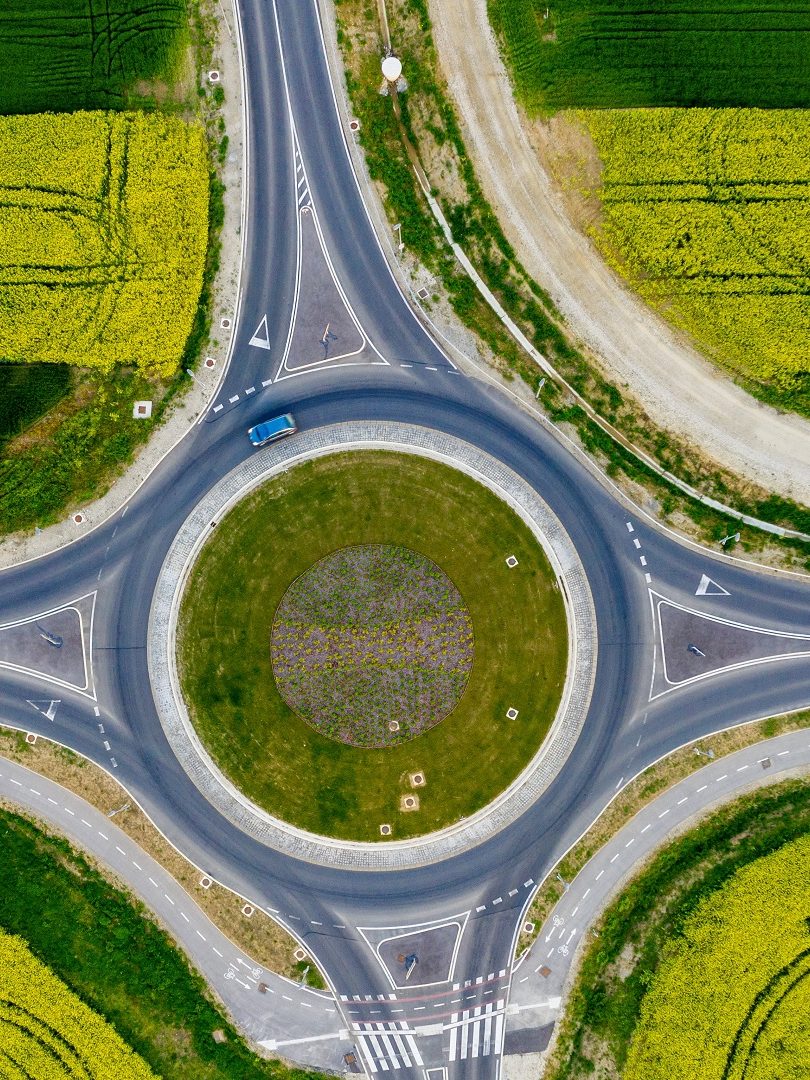 Drone view of roundabout with car driving
