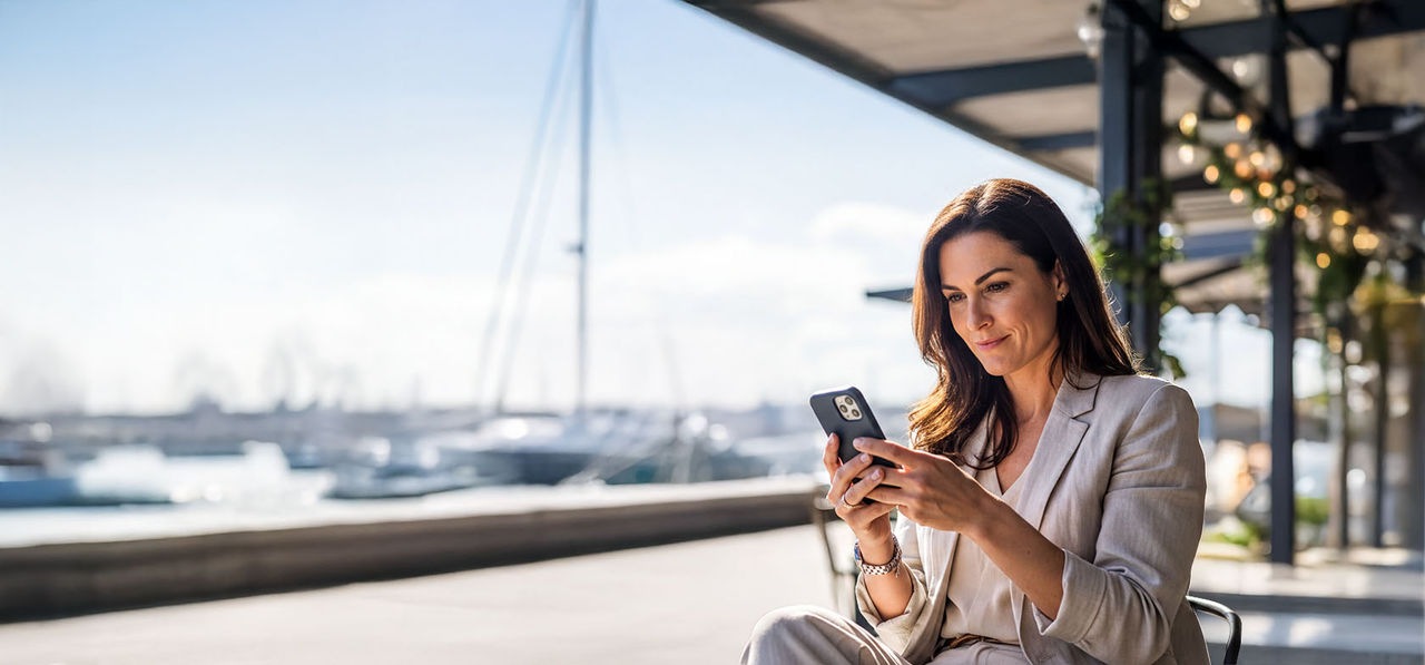 Woman sitting, using a mobile phone