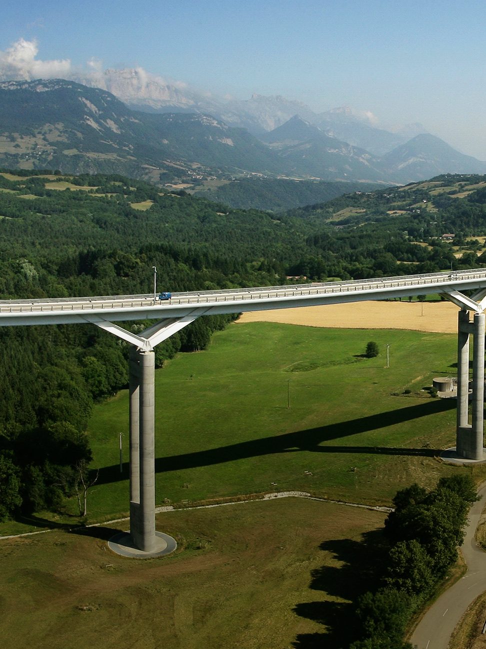 Bridge through green hills