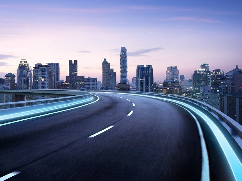 A winding road on a mountain being lit up at nightshutterstock-196956422