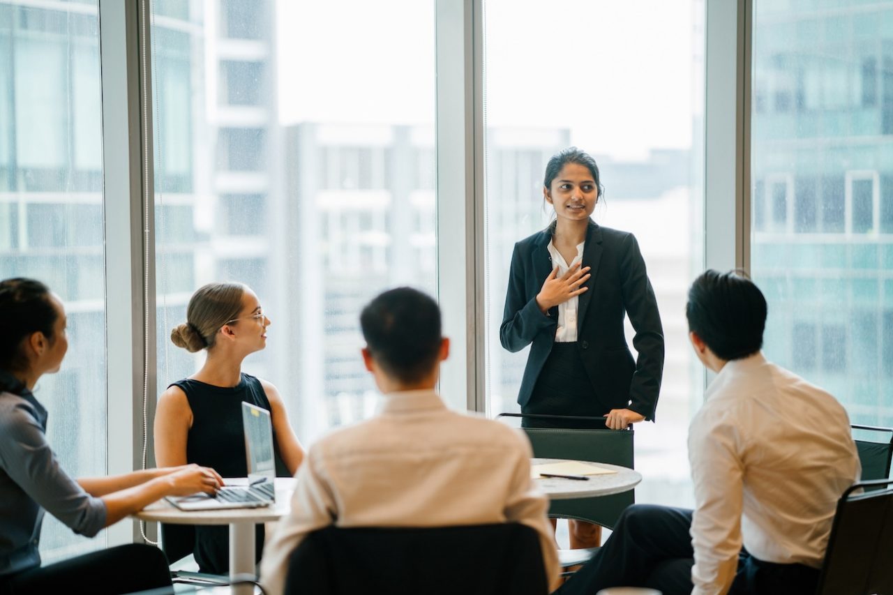 A woman presenting to team,  leading a meeting, training or presentation in their office during the daytime

shutterstock-1132524026