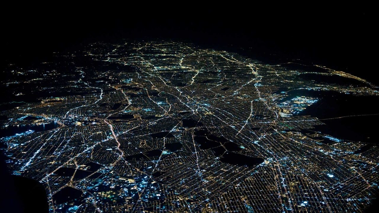 A nighttime aerial view of a populated urban landscape