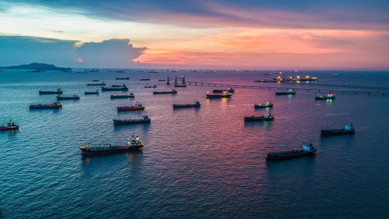 Aerial top view tanker ship park in sea, Crude oil tanker ship and LPG  tanker ship loading in sea at sunset.