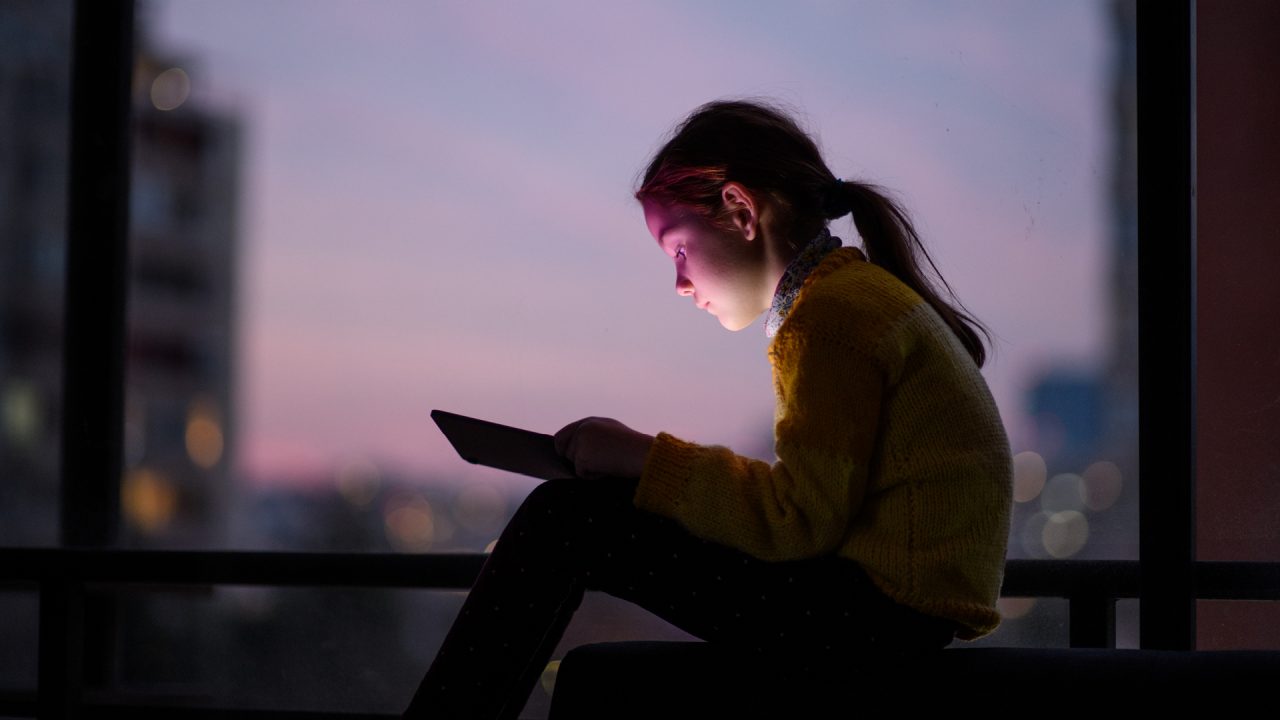 Young girl looking at a computer tablet device