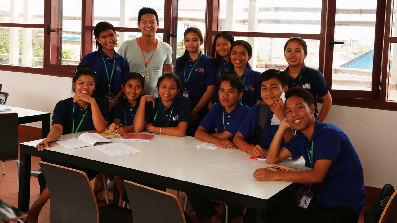 David Sit (third from left) pictured with school children in a recent visit to Cambodia. 