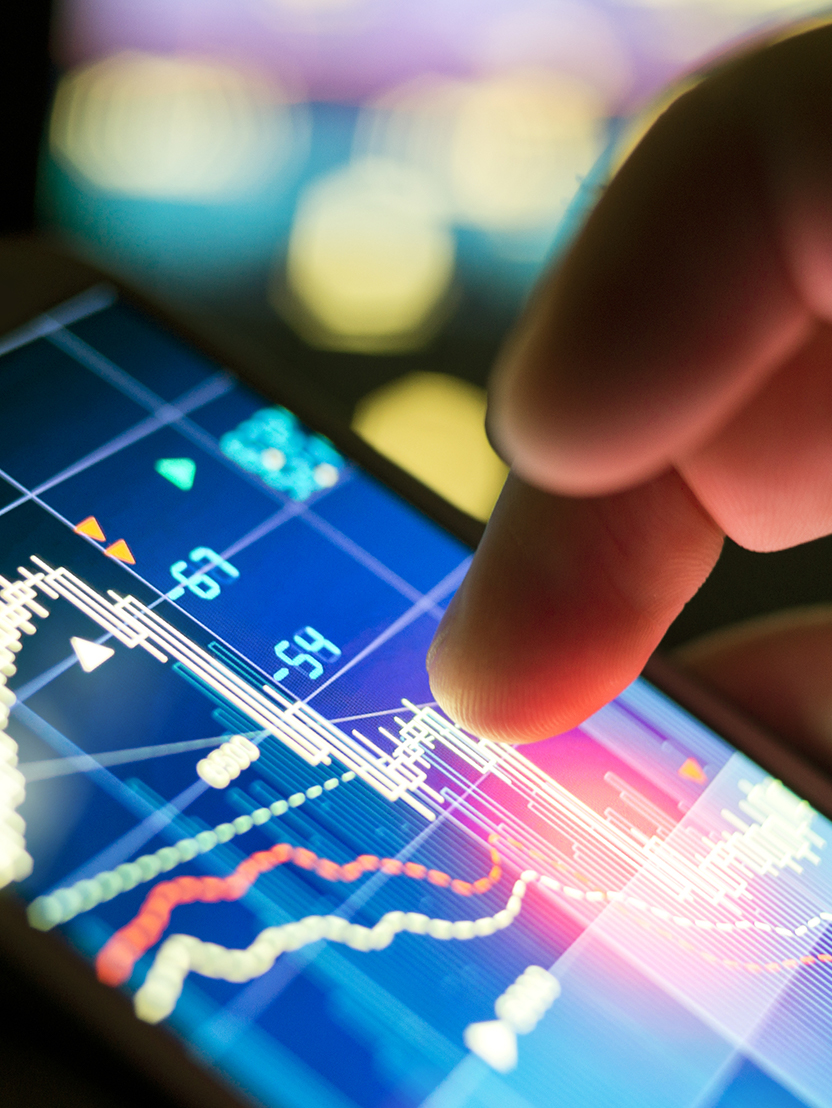 A businessman using a mobile phone to check stock market data