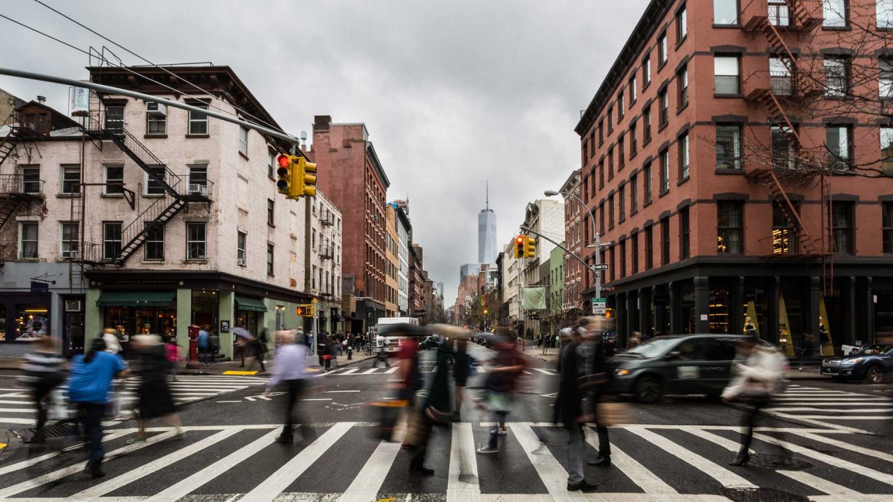 Pedestrians using a crossing in a busy urban city