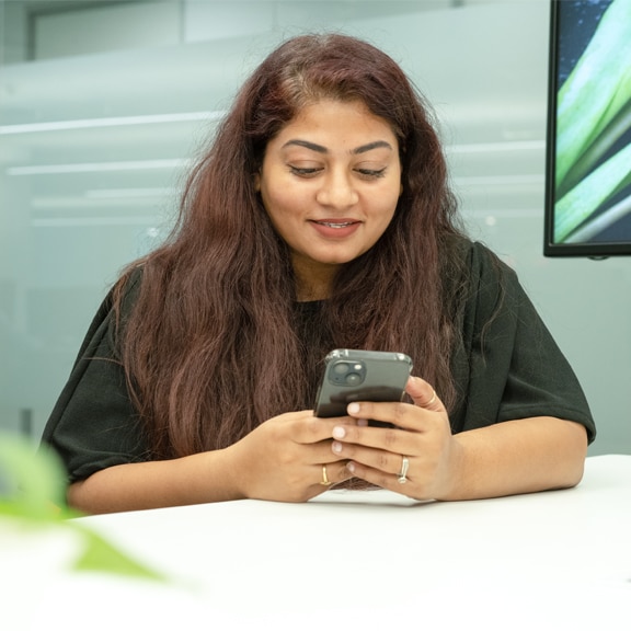 A woman smiling towards colleague