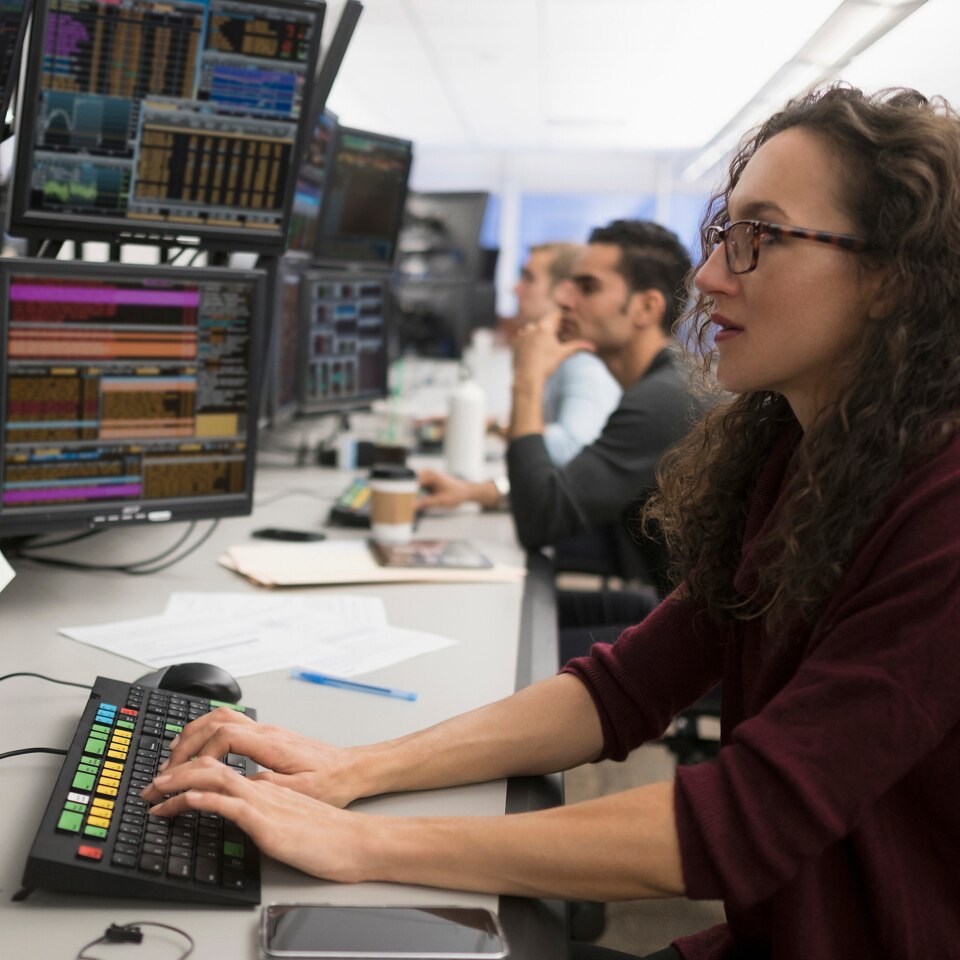 Female stockbroker working at her desk