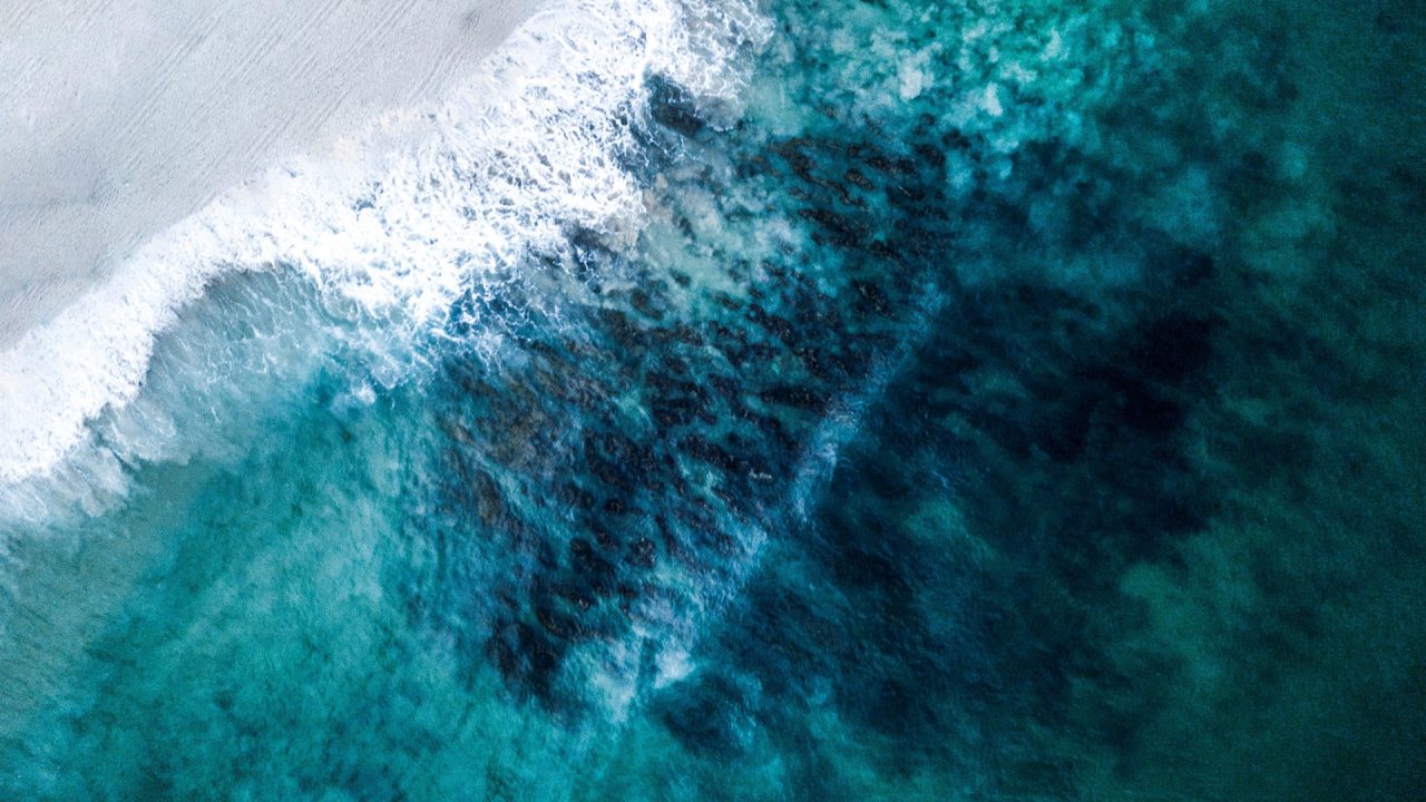 birds-eye-view of seawater on beach