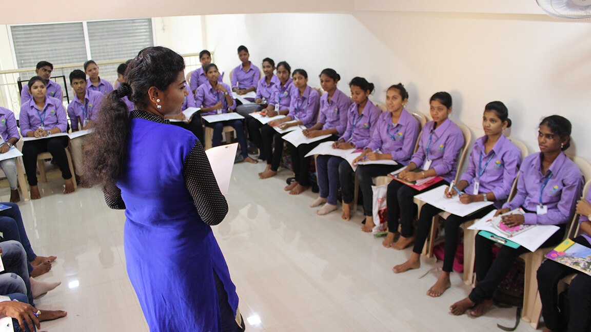 Women being taught in classroom