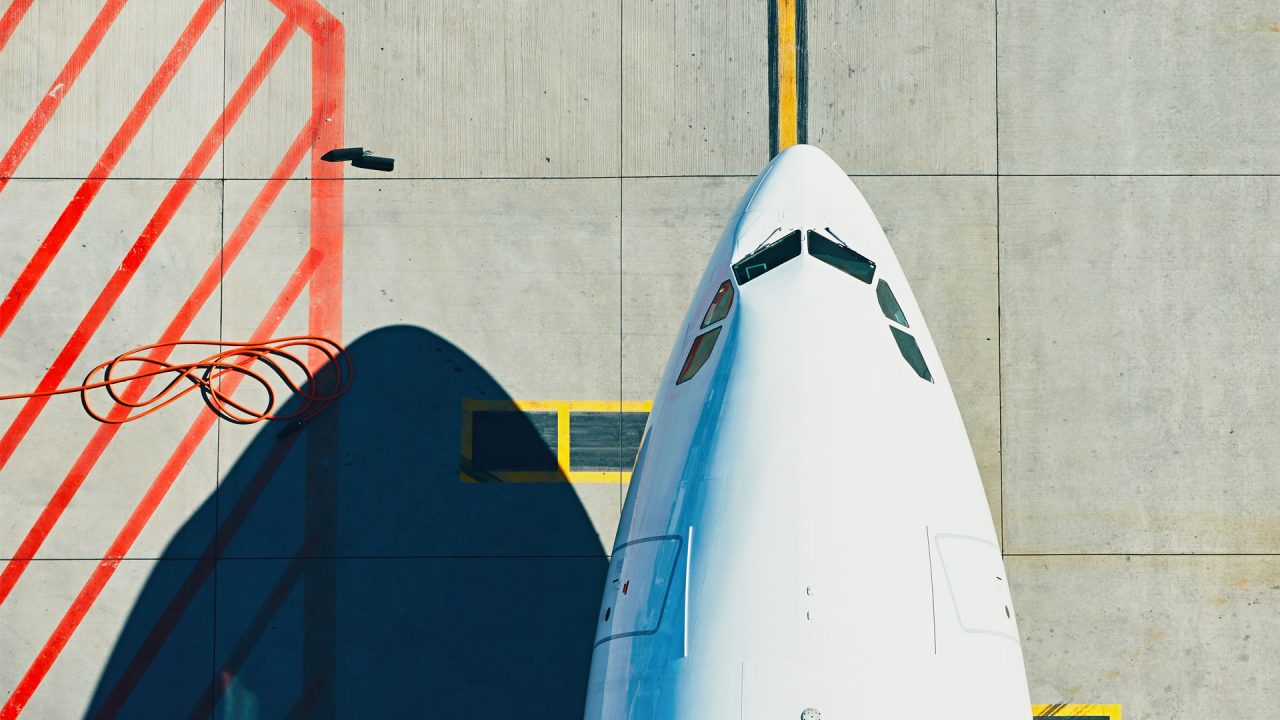 Aerial view of the nose of a passenger plane on a runway