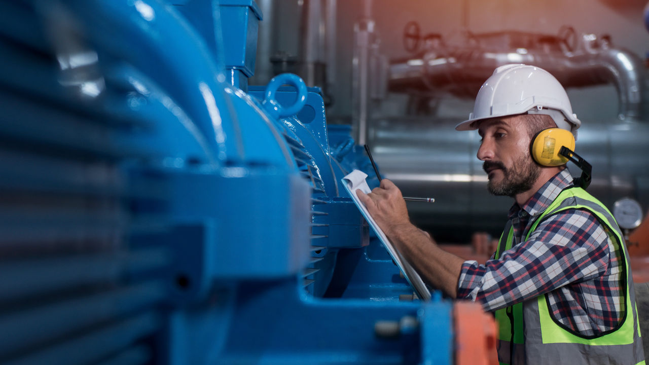 Industrial professional conducting a safety check on machinery