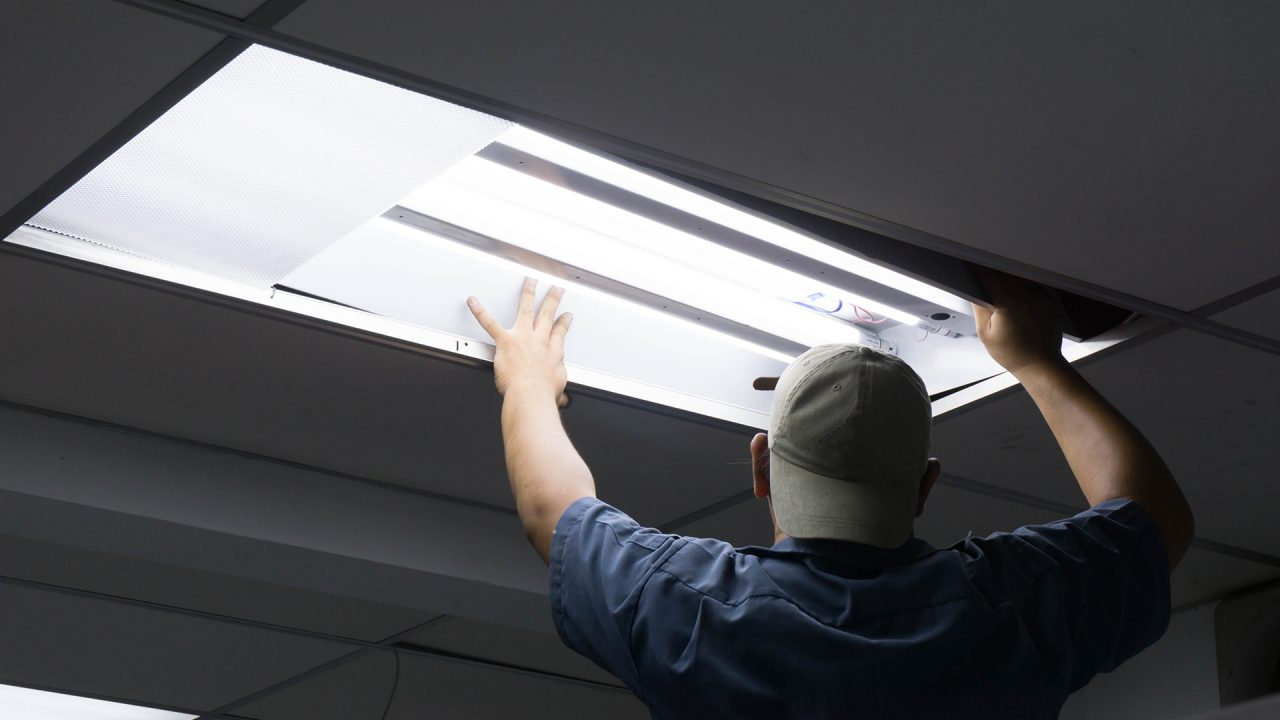 a man fitting LED lights in the ceiling 