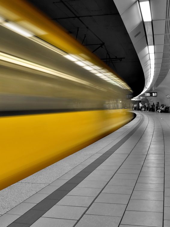 metro station with vehicle in colour and platform in black and white