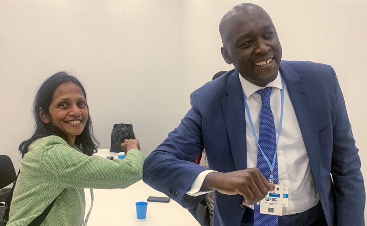 Shemara Wikramanayake, Managing Director and Chief Executive Officer of Macquarie Group, greeting Makhtar Diop, Managing Director of the International Finance Corporation, at the Multilateral Development Banks COP26 pavilion.