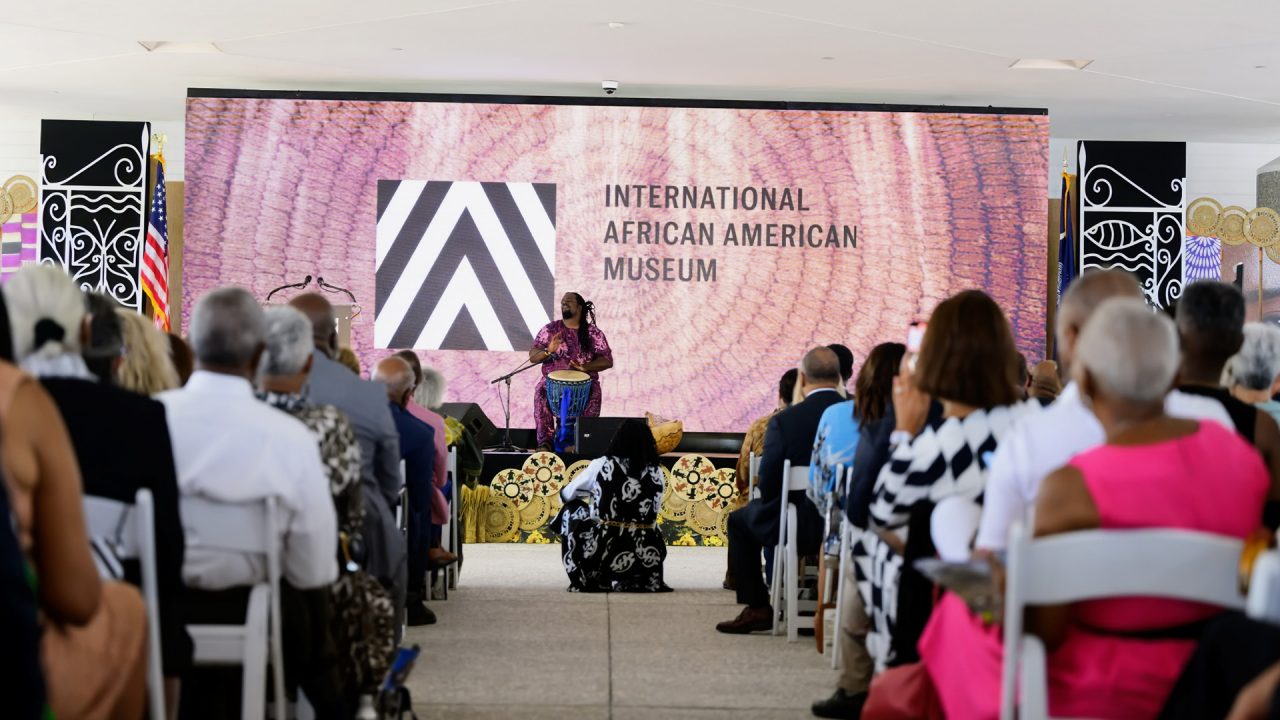 A man performing on the drums at the International African American Museum