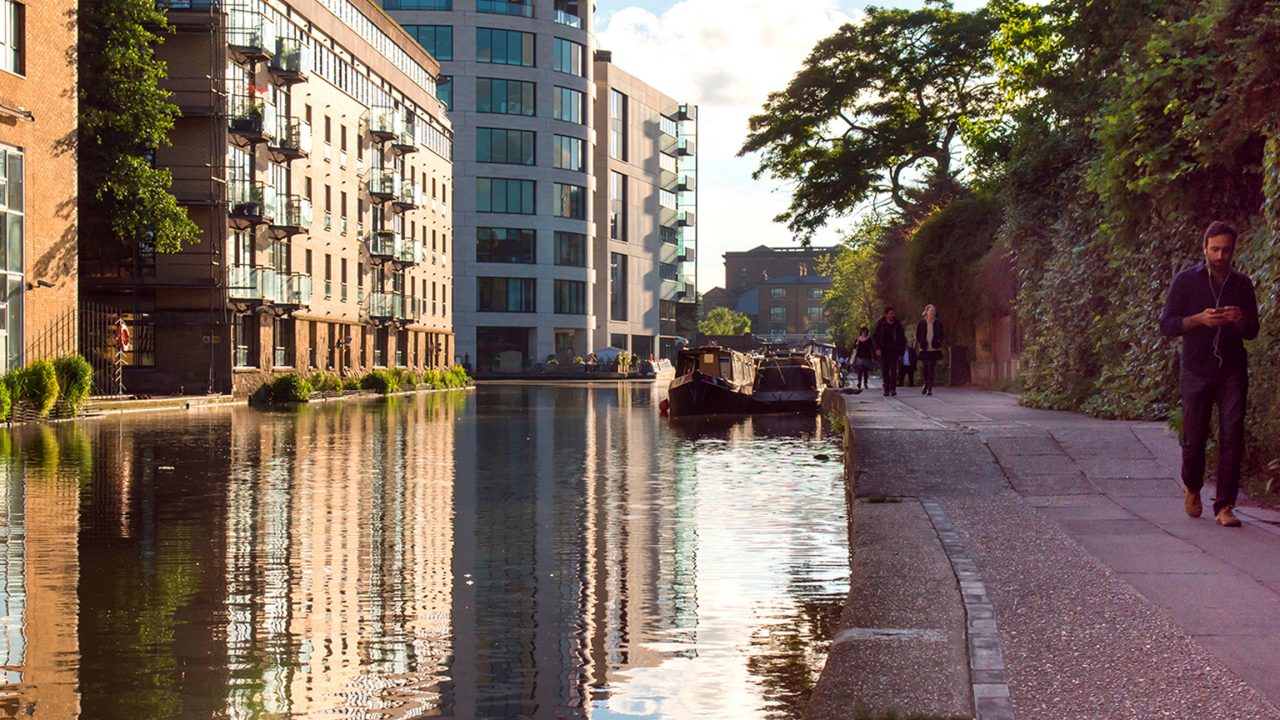 Pedestrians walk on the towpath of the Regent's Canal near King's Cross in north London
