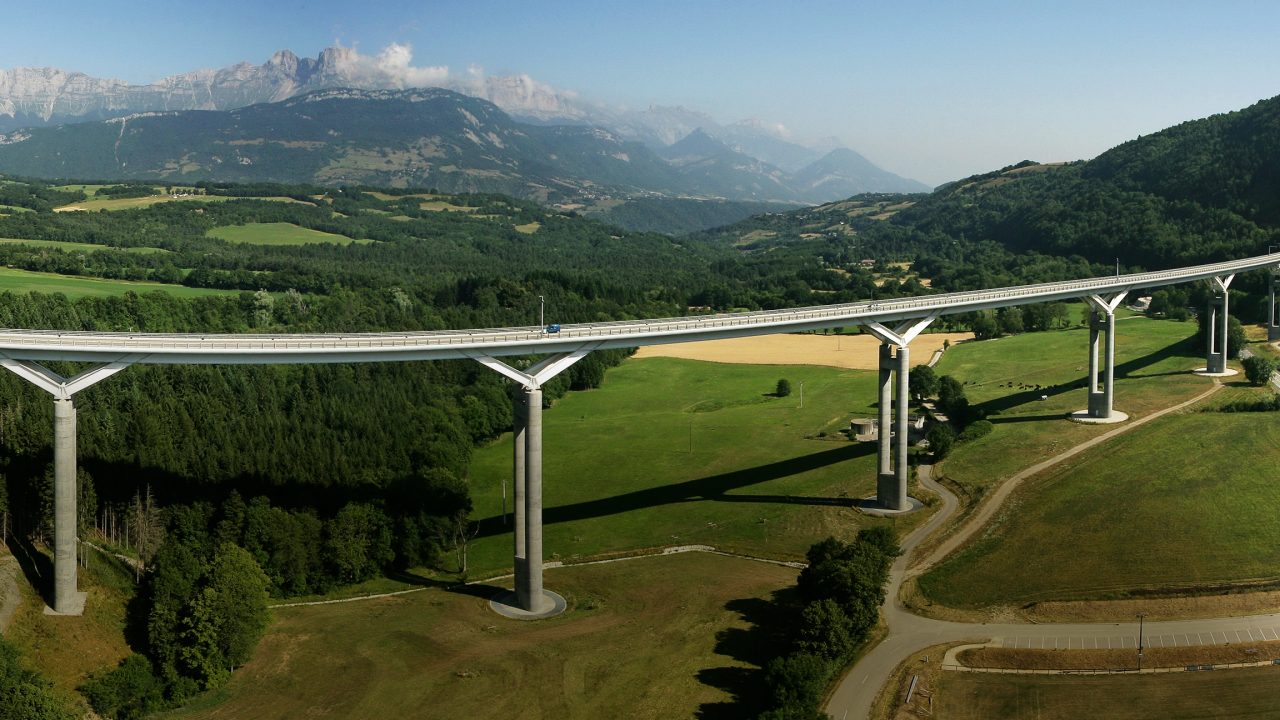 Bridge through green hills