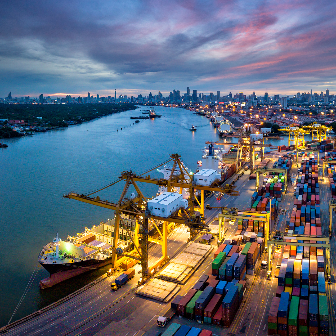 Young woman controlling home with a digital touch screen panel installed on the wall in the living room. Concept of a smart home and mobile application for managing smart devices at home