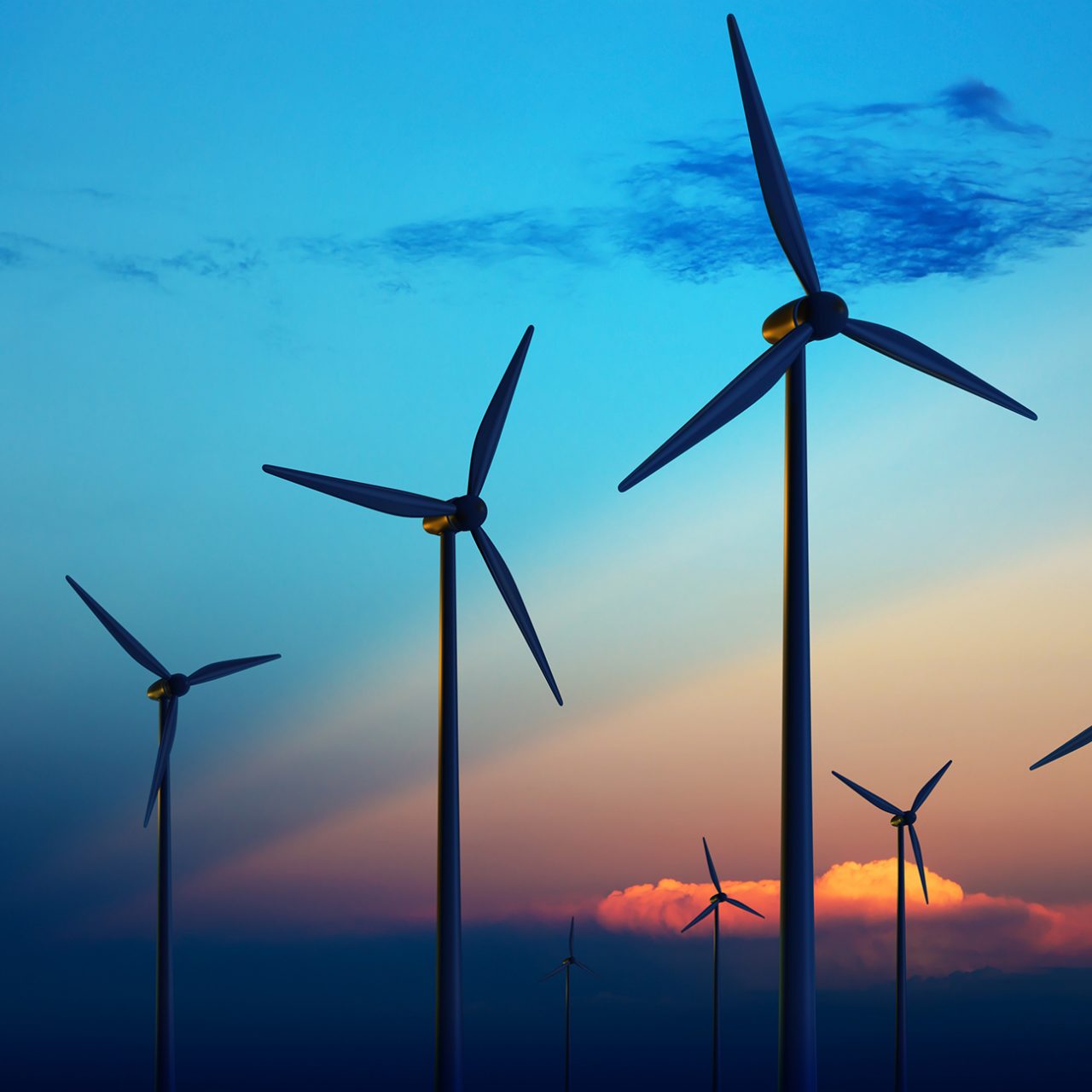 Wind turbine farm with rays of light at sunset