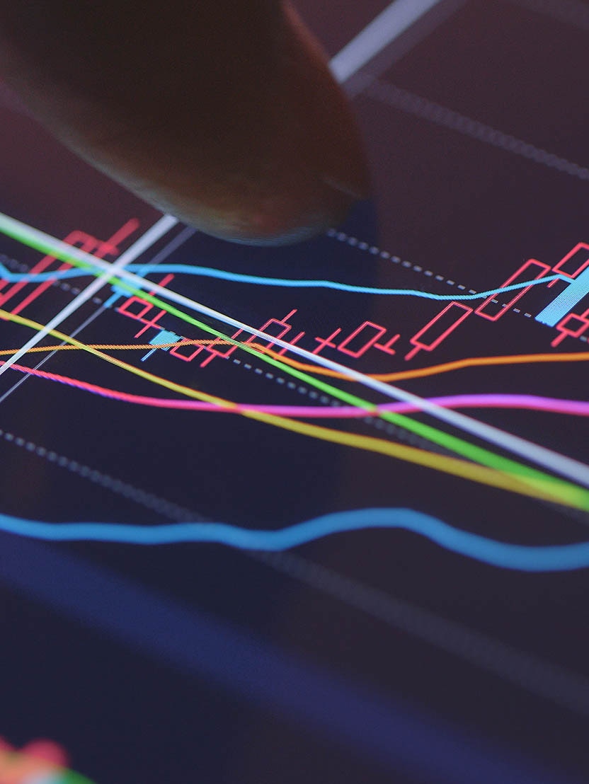 A stock trader checking technical markers of a stock on a computer screen