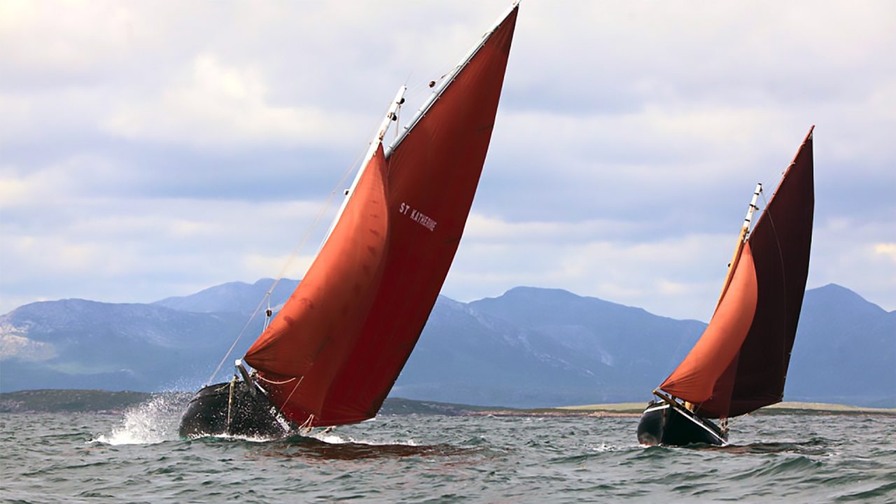 Two red sailsboats in the Irish Sea
